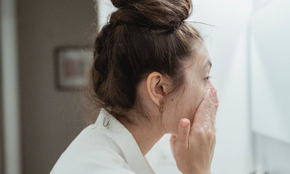 Side View of Woman Washing Her Face  .pexels