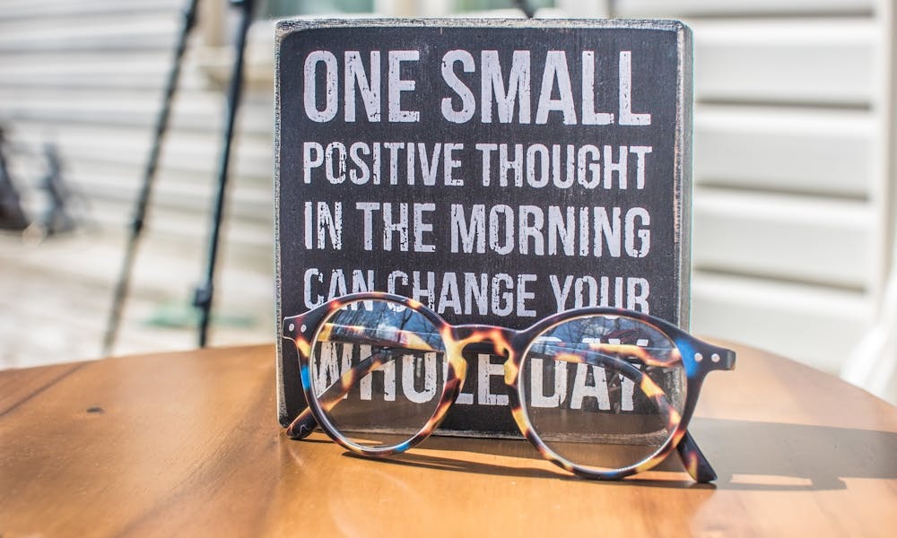 Photo of a Sign and Eyeglasses on Table .pexels