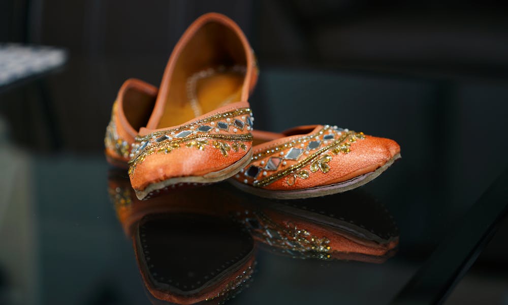 Trendy bridal oriental ballet flats on glass table .pexels