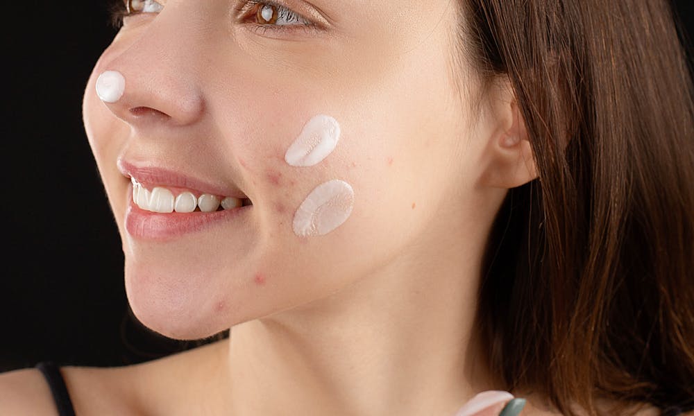 Woman Applying Facial Cream .pexels