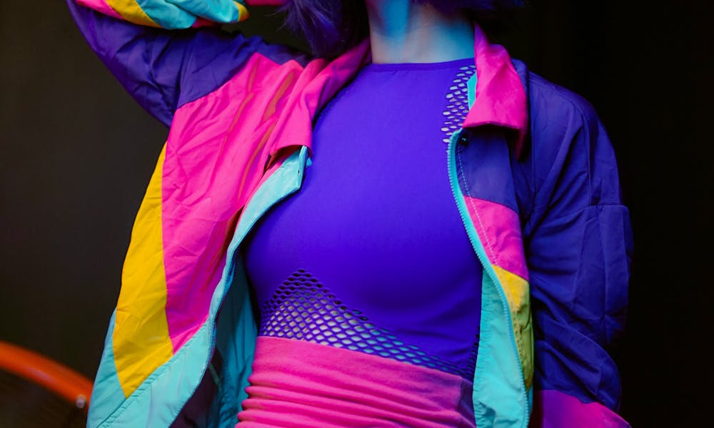 Young Woman Wearing Neon Colored Clothes Sitting on a Chair .pexels