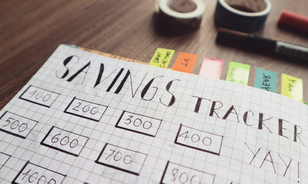 Savings Tracker on Brown Wooden Surface .pexels