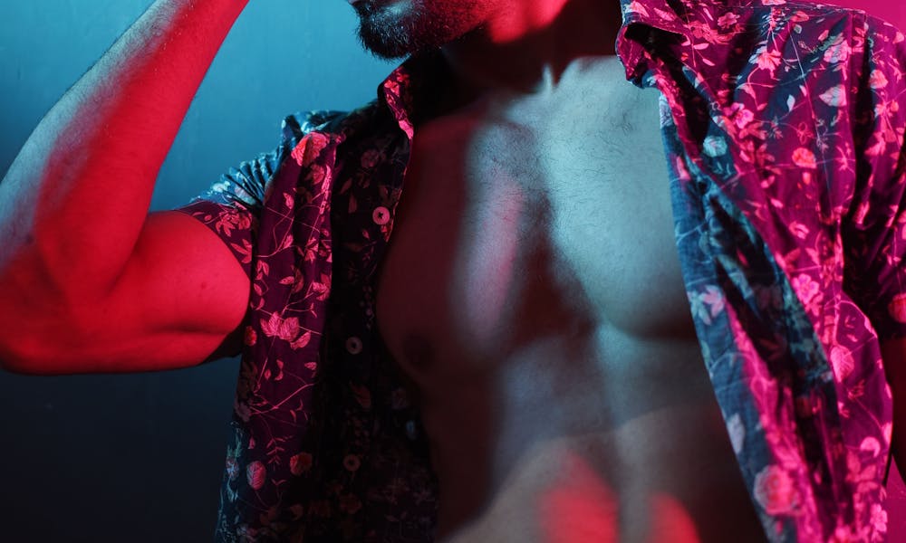 A shirtless man with a shirt on his head .pexels