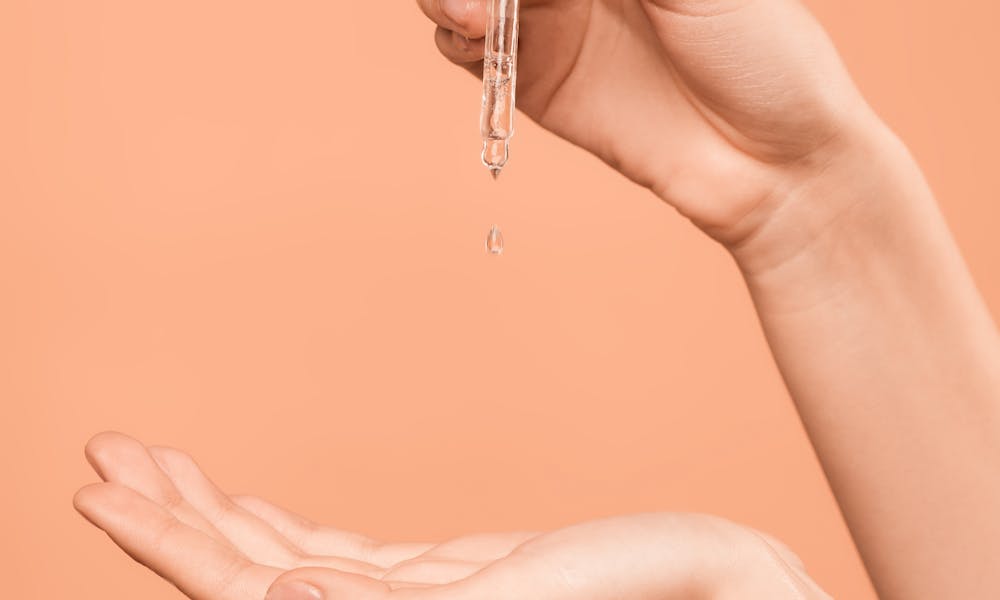 Person Holding White and Gold Dropper .pexels