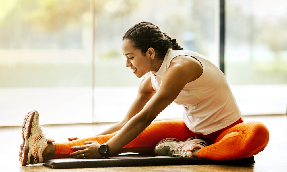 Woman Stretching on Ground .pexels