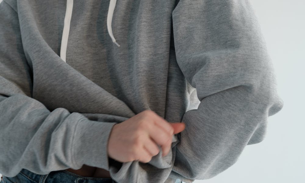 Stylish woman wearing gray hoodie .pexels