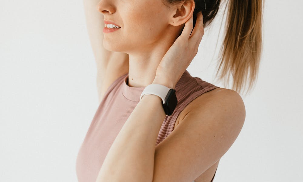 Young woman touching and tying hair .pexels