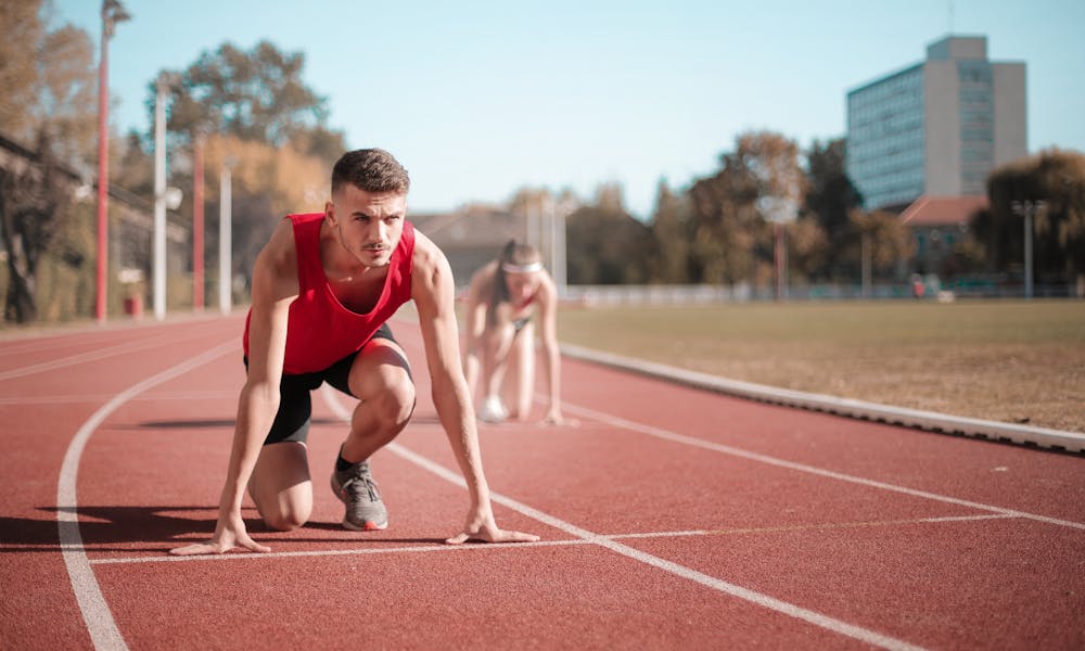 Strong sportsmen ready for running on stadium .pexels