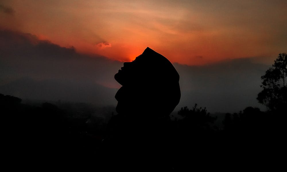 Silhouette of person against sunset sky .pexels