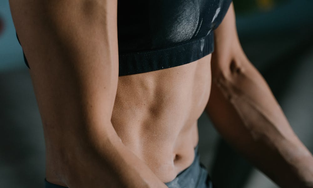 Anonymous fit sportswoman relaxing after training training .pexels