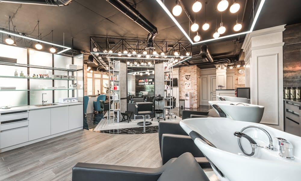 Backwash chairs with sinks placed in spacious modern beauty salon with stylish design and various cosmetology products with professional equipment .pexels