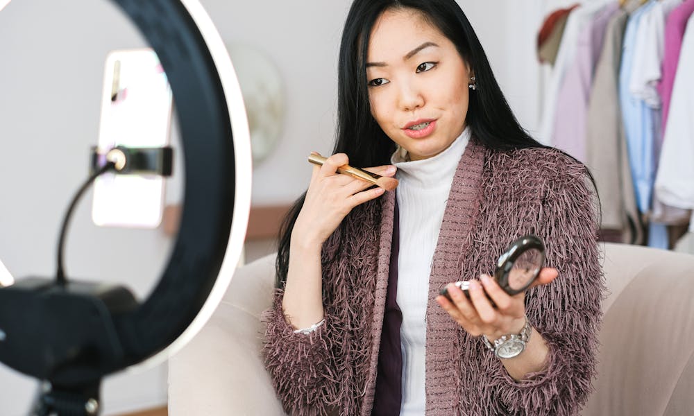 Vlogger Applying Makeup and Live Streaming with her Phone .pexels