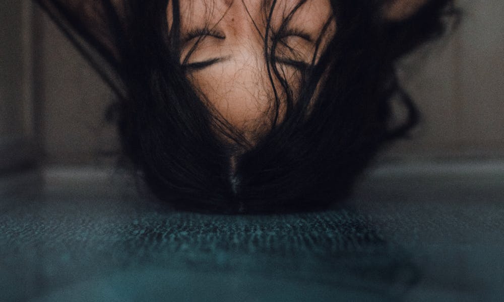 Woman Leaning On Glass Panel With Head Up .pexels