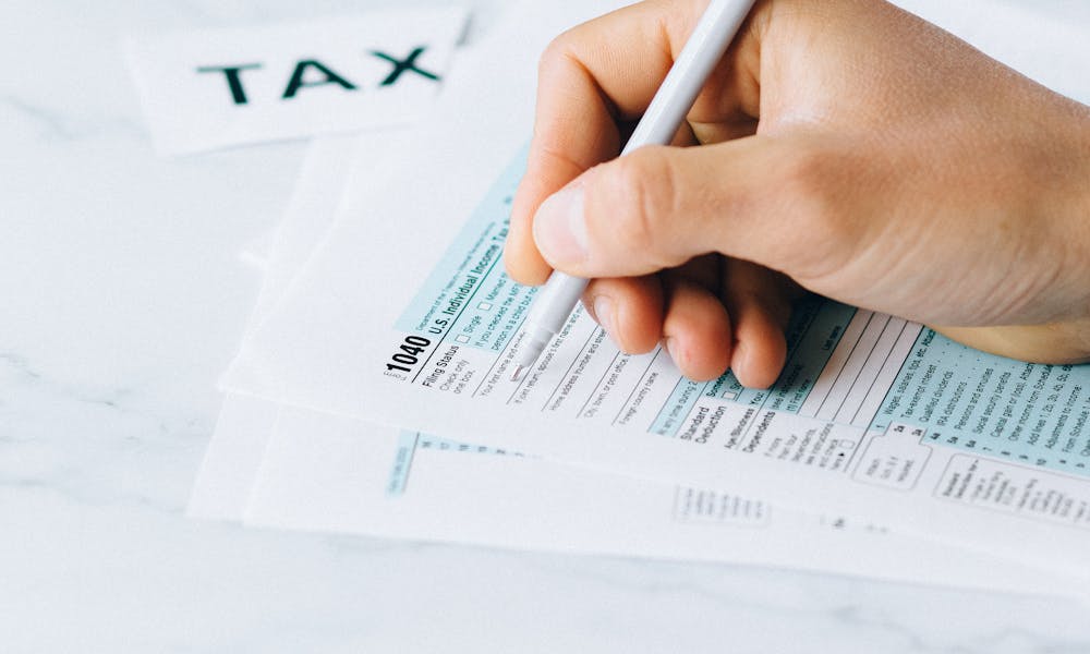 Person Filing Tax Documents .pexels