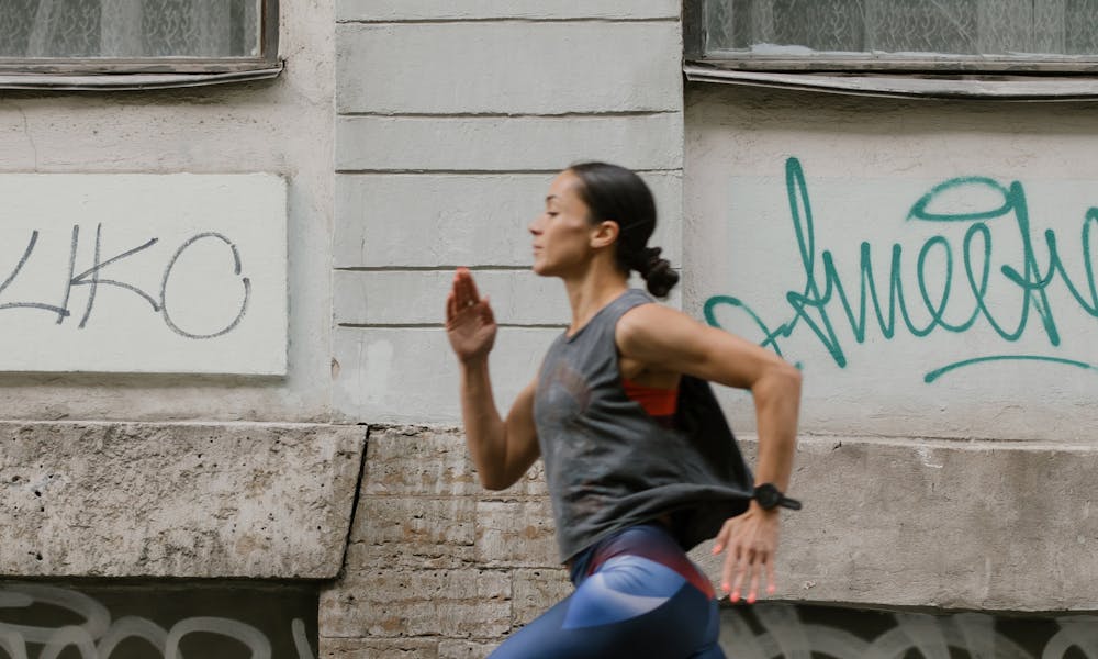 A Side View of a Woman Jogging on the Street .pexels