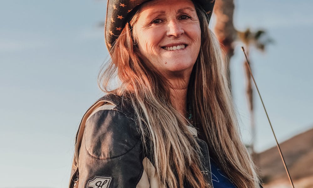Woman in Cowboy Hat and Leather Jacket Smiling .pexels