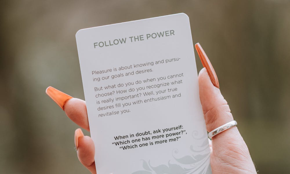 Anonymous woman showing inspirational card with motivational text .pexels