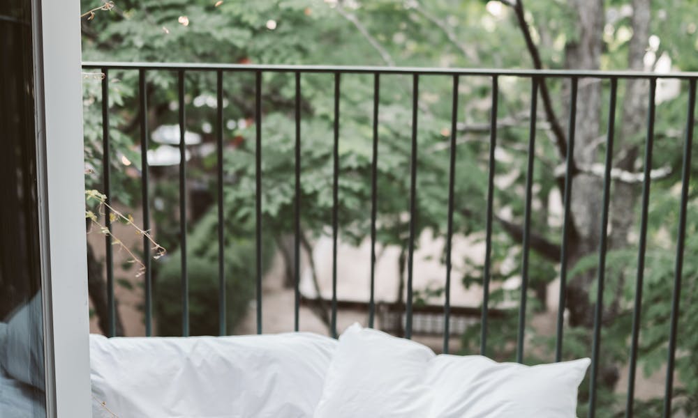Laptop On Bed Near The Balcony .pexels