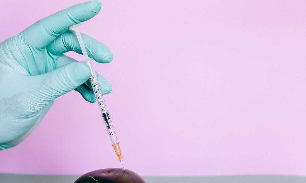 Person Making A Study On Covid-19 Vaccine By Injecing On A Vegetable .pexels