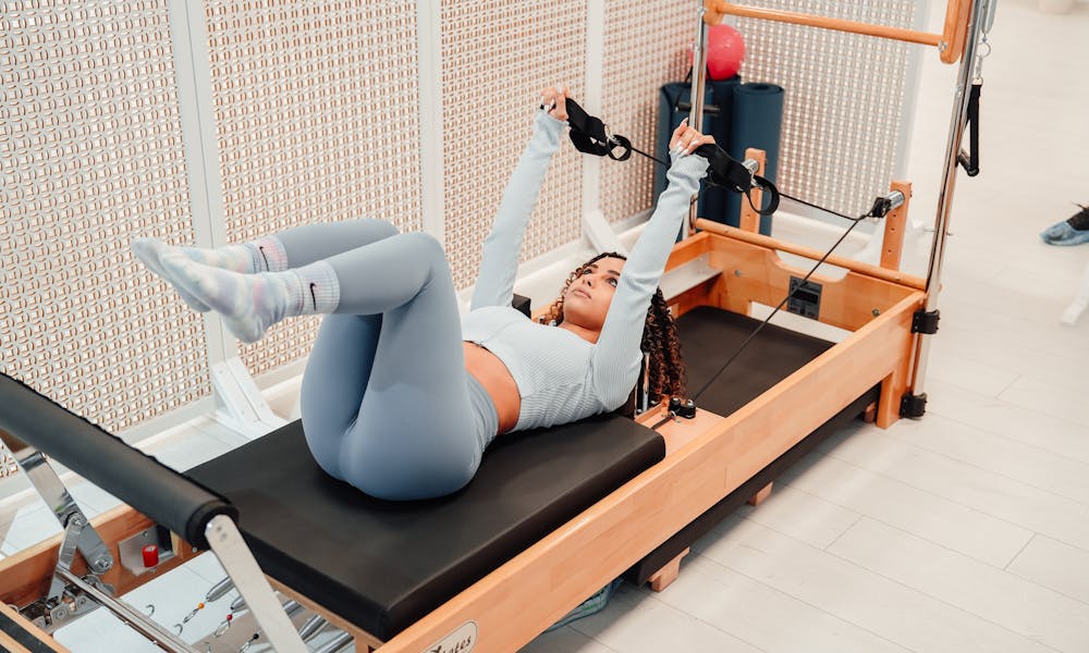 Woman doing pilates on a reformer .pexels