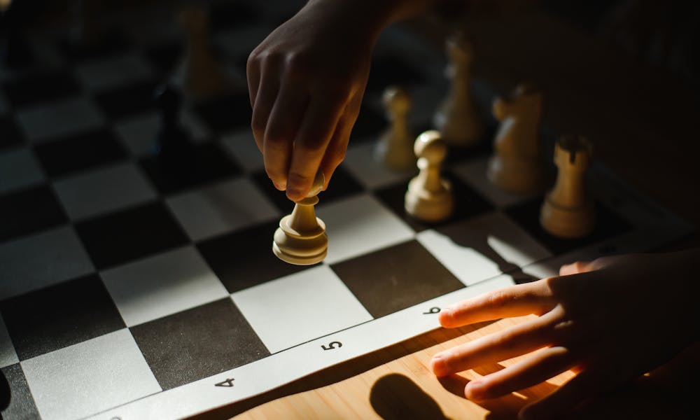 Close-Up Shot of a Person Playing Chess .pexels