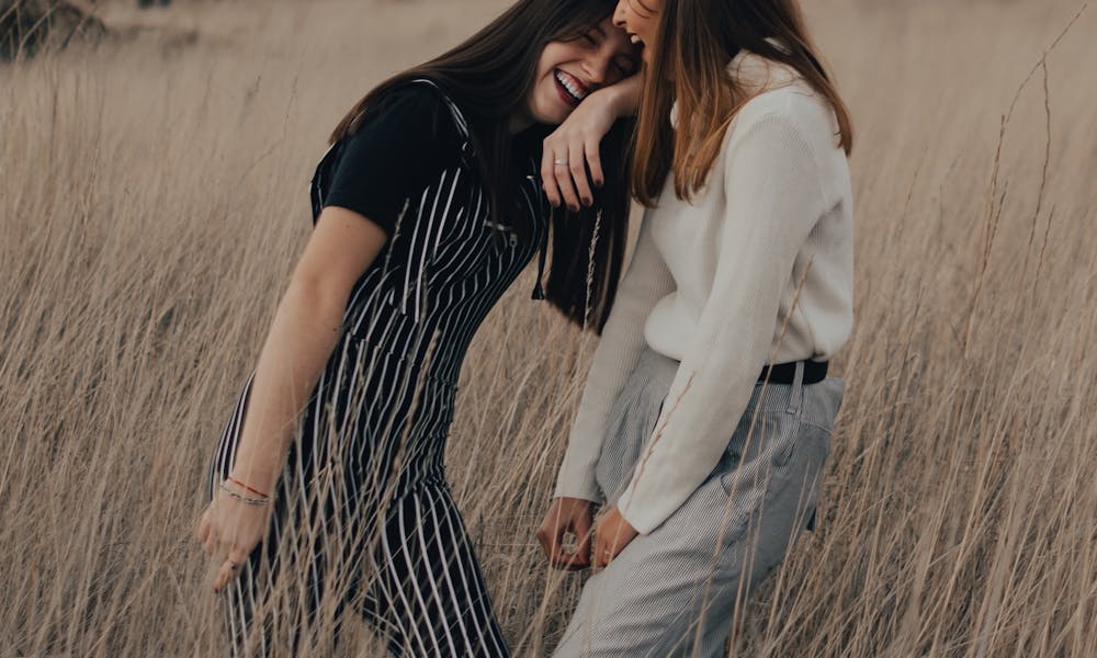 Happy Girls Standing on Brown Grass Field .pexels