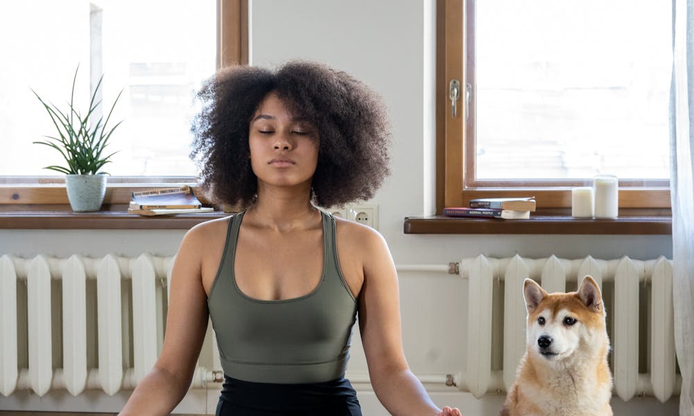 Woman Meditating Beside her Dog .pexels