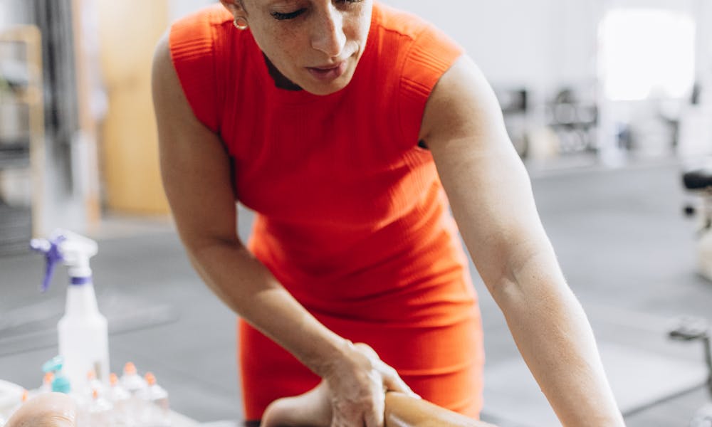 A woman is getting a massage on her leg .pexels