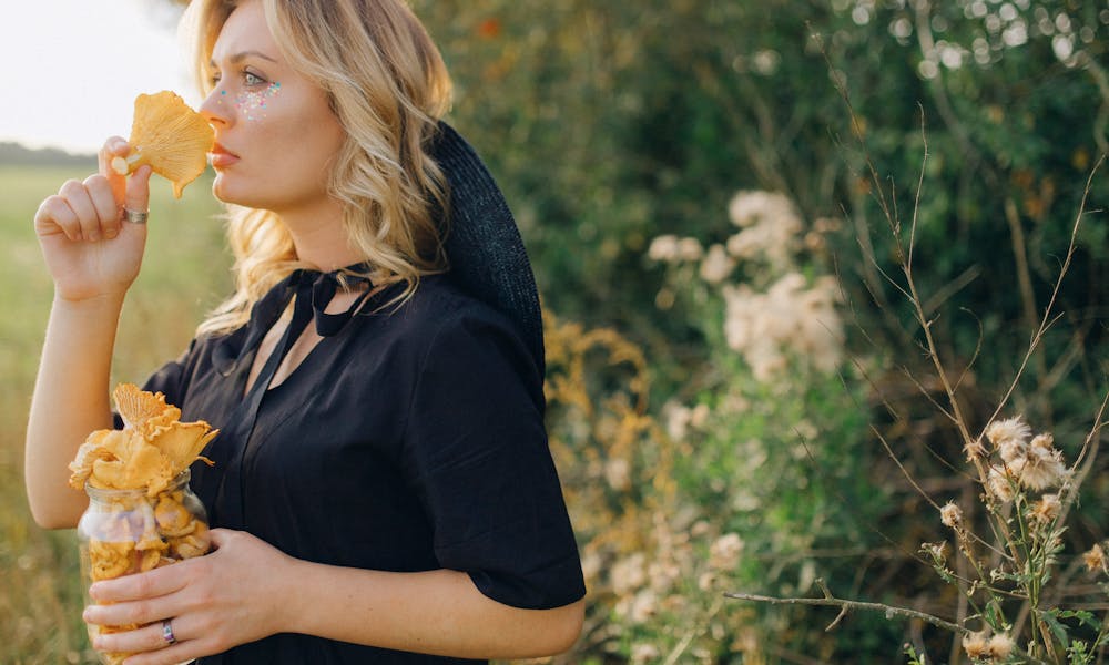 Woman in Blue Shirt Standing Near Green Plants .pexels