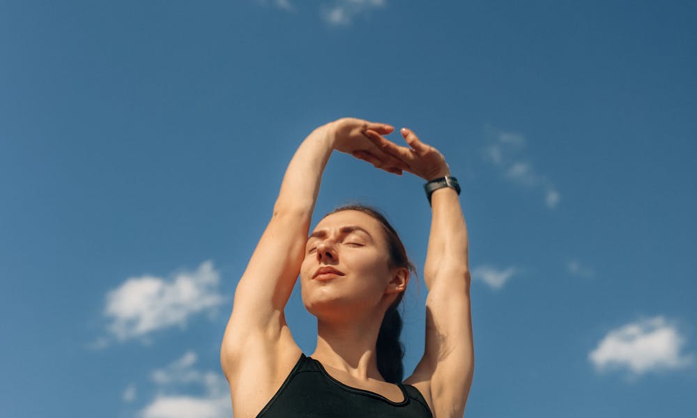 Woman in Black Sports Bra Raising Her Hands .pexels