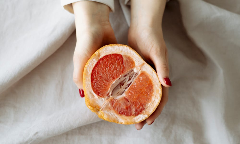 Person Holding Sliced Orange Fruit .pexels