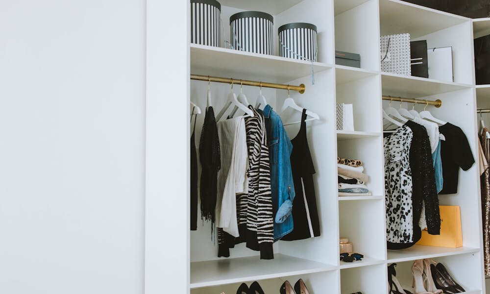 Clothes Hanged on White Wooden Cabinet .pexels