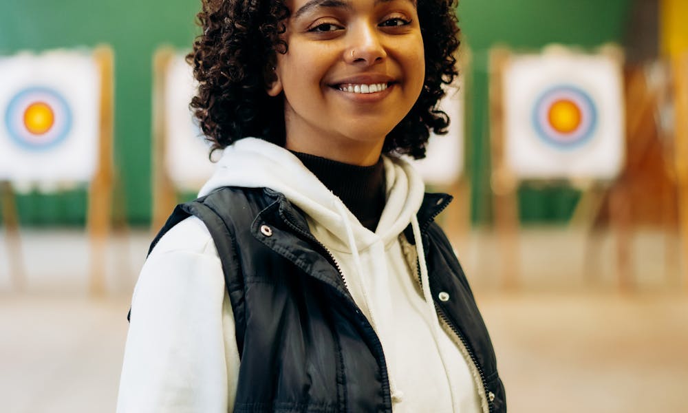 Smiling Woman in White Dress Shirt and Black Vest .pexels