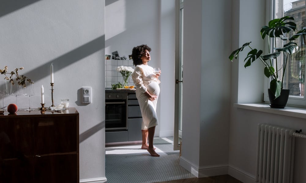 Woman in White Dress Standing Beside White Wall .pexels