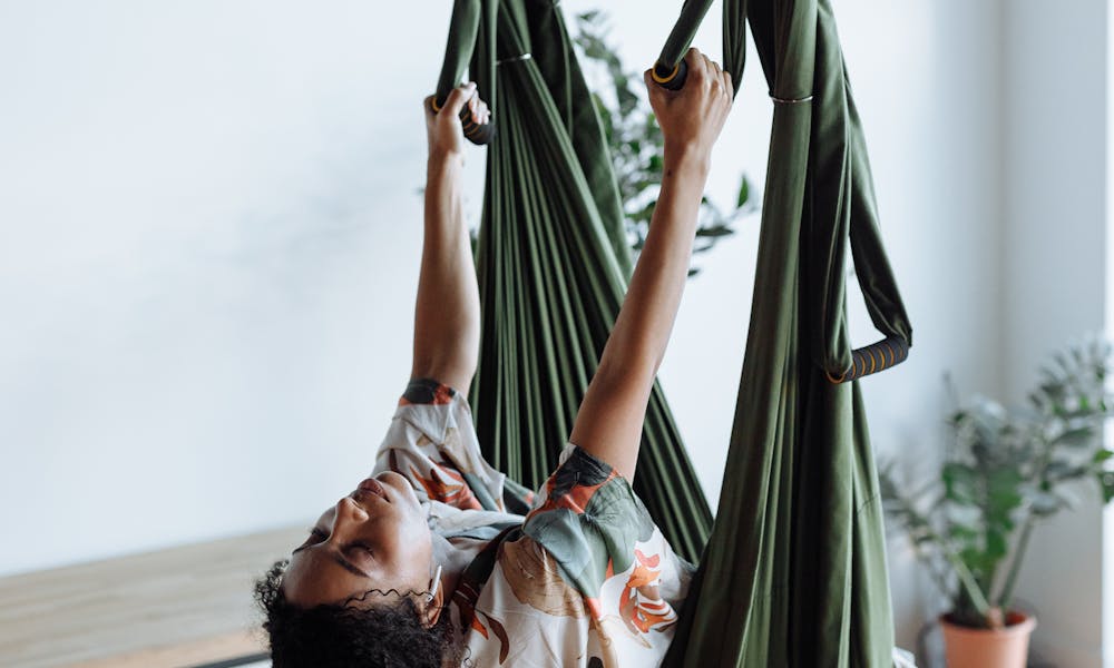 Woman in White and Green Floral Dress Lying on Hammock .pexels