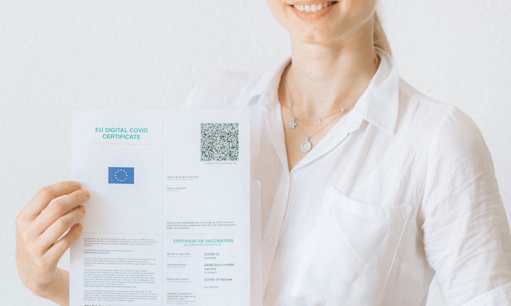Woman in White Button Up Shirt Holding White Printer Paper .pexels