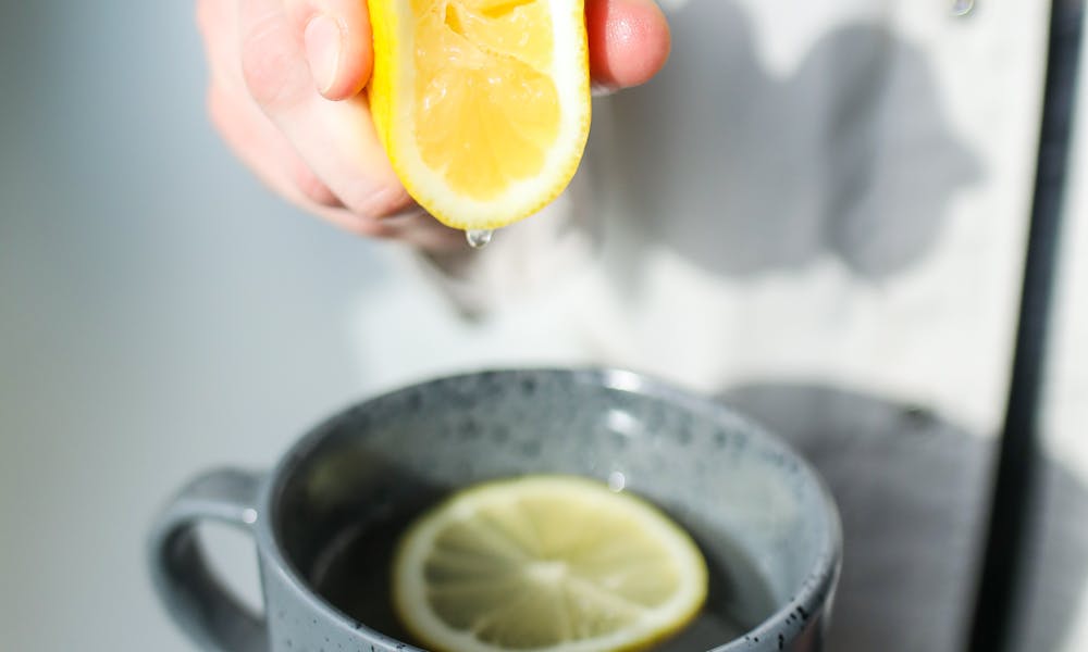 Photo of Person Squeezing Lemon .pexels