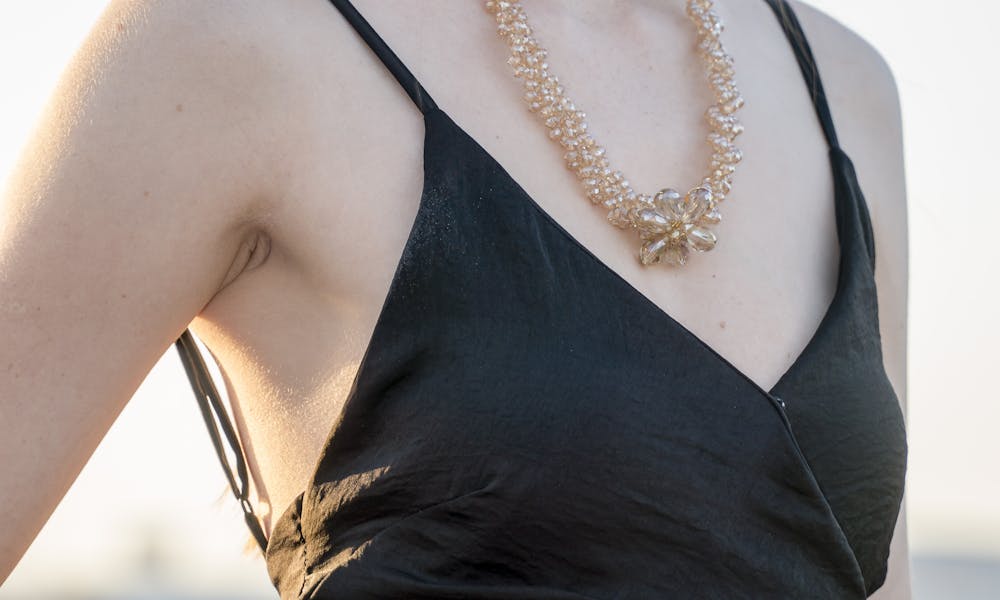 Woman Wearing Black Spaghetti Strap Dress and Gold-colored Necklace .pexels