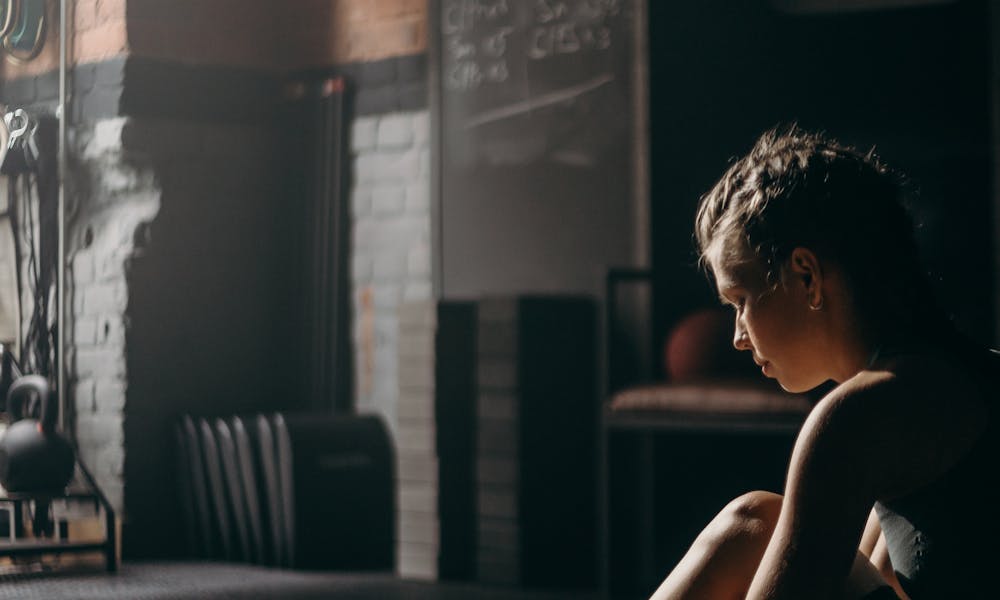 Woman in Black Tank Top Sitting on Chair .pexels