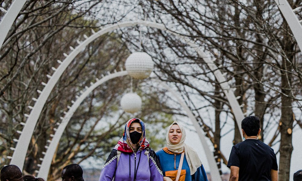 Muslim women in traditional clothes strolling in park .pexels