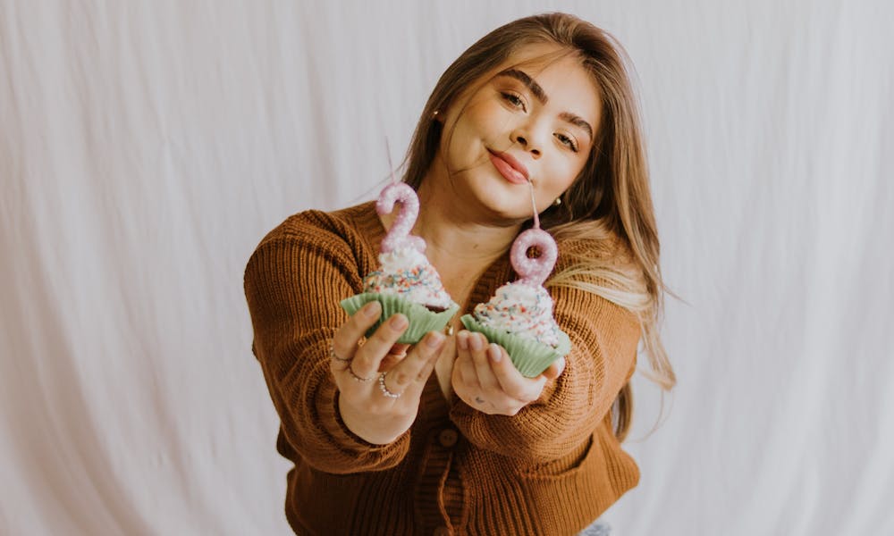 Young Woman Celebrating with Birthday Cupcakes .pexels