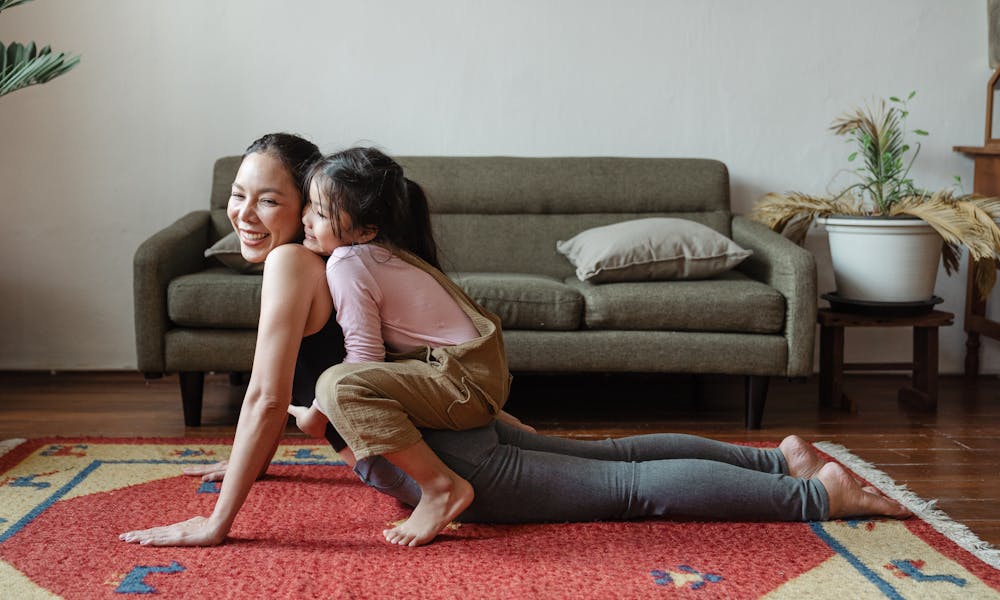 Photo of Girl Hugging Her Mom While Doing Yoga Pose .pexels