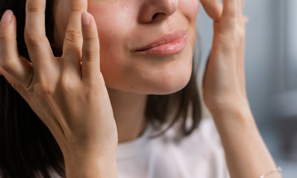 A Woman in White Shirt Patting the Sides of her Eyes .pexels
