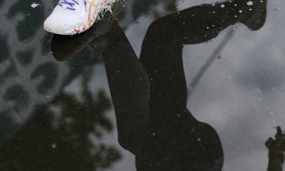 A Person Running on Wet Concrete Floor .pexels