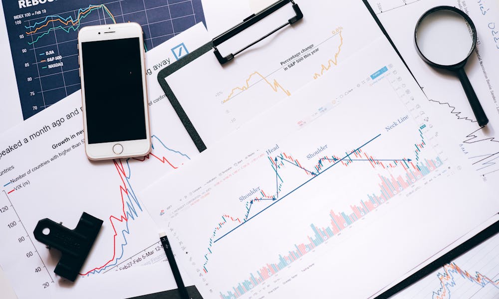 Silver Iphone 6 on Clipboard with Statistical Data  .pexels