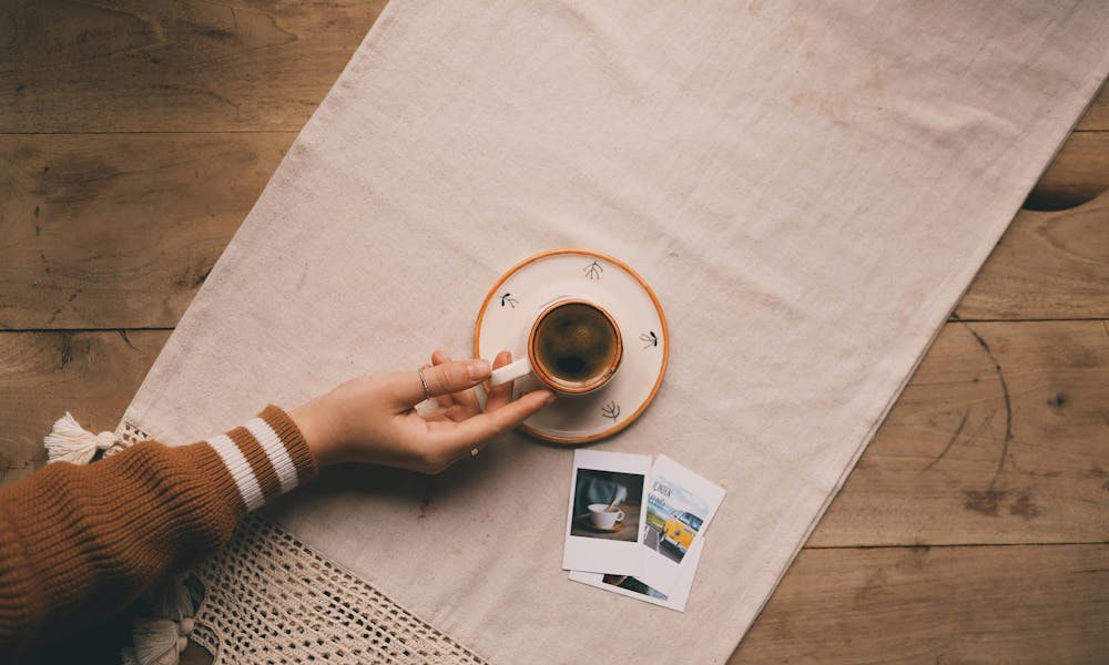 Serene Coffee Moment with Polaroids on Table .pexels