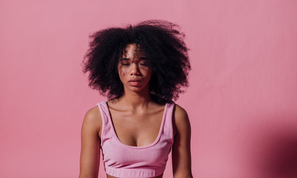 Woman in Pink Crop Top and Jogging Pants Practicing Yoga .pexels
