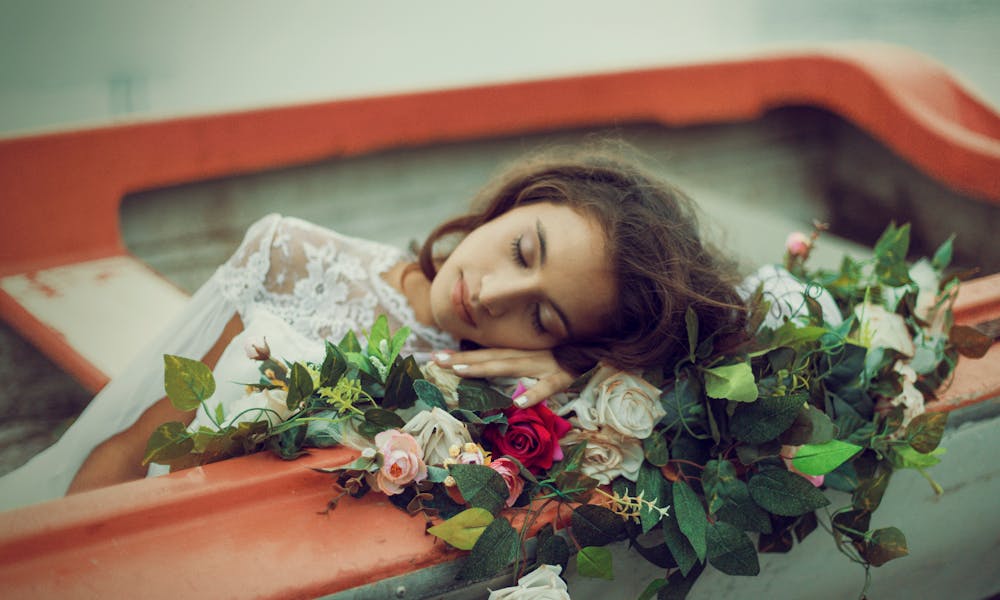 Woman Lying Down with Flowers in Boat .pexels