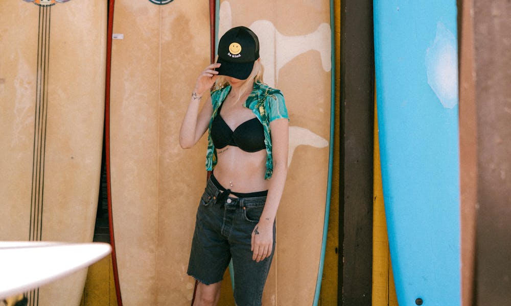 Woman and Surfboards behind .pexels