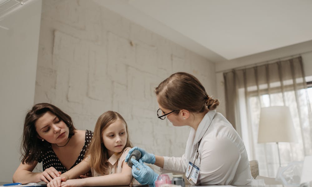 A Doctor Holding a Glucometer .pexels